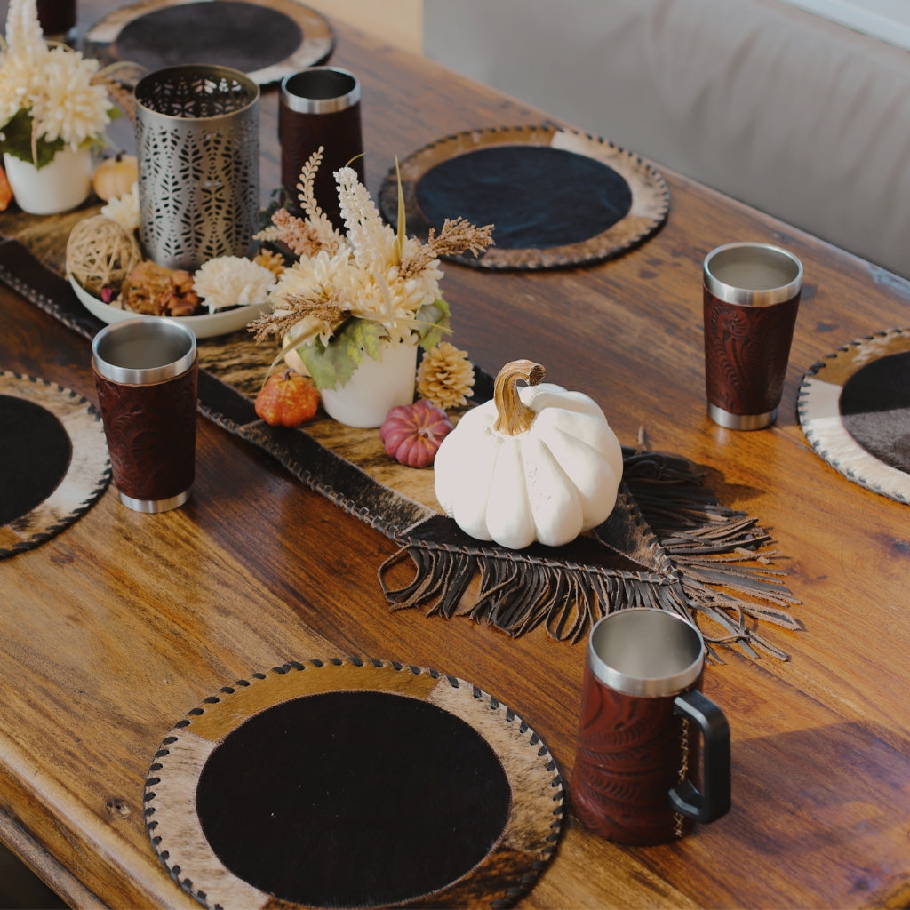 American West leather home decor and western table accents featuring handcrafted leather placemats, fringe table runner, and rustic western drinkware