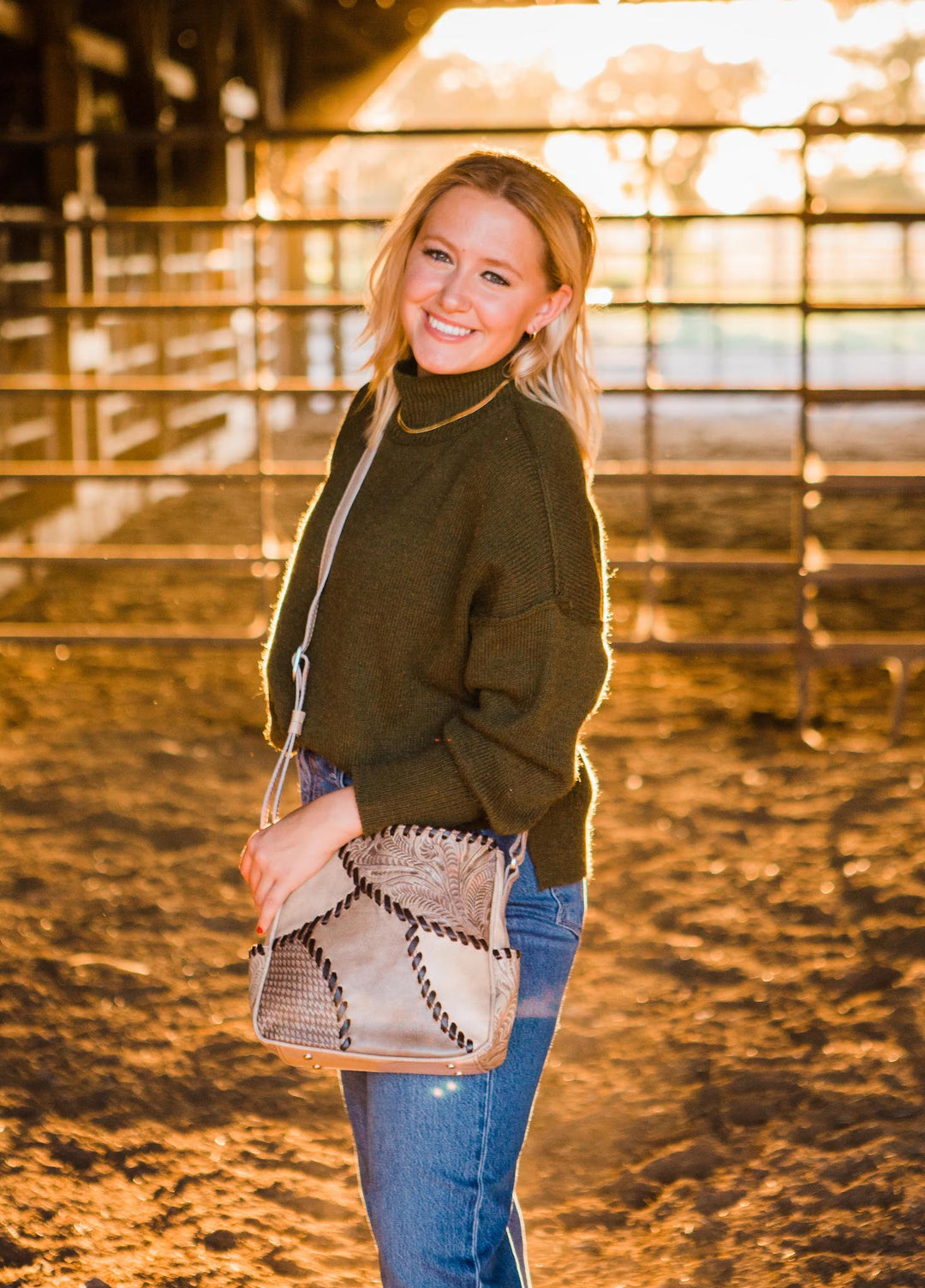 Lifestyle with model of Gypsy Patch crossbody bag in sand with hand tooled leather accents