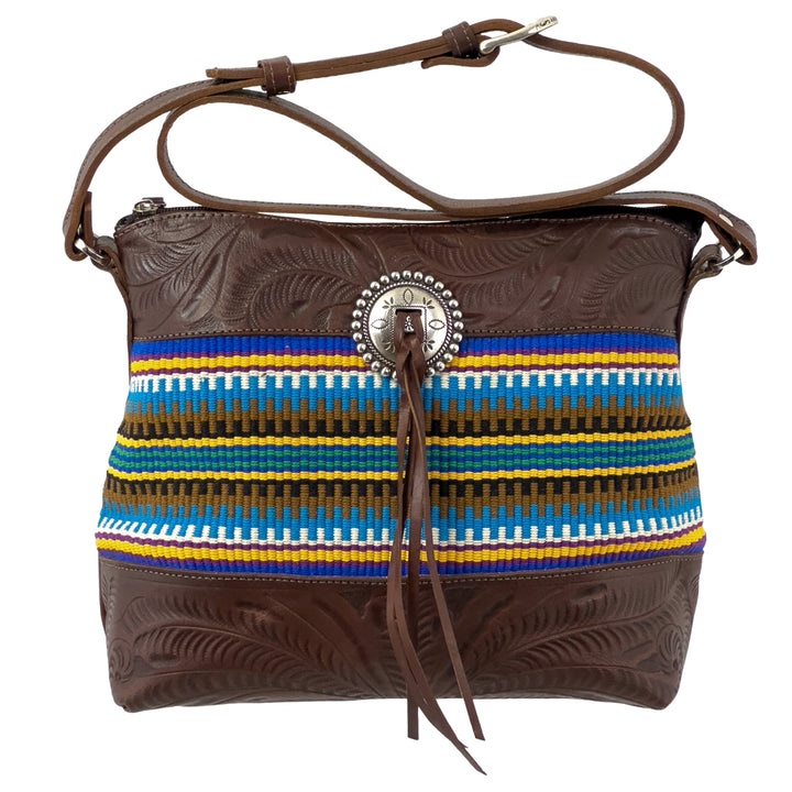 Maká Festive shoulder bag in brown with hand tooled leather, blue themed hand woven tapestry, and bolo concho with tassle