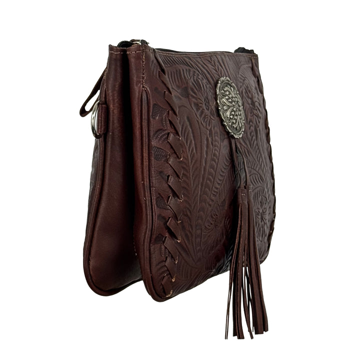 Side view Lariats and Lace multi-compartment Crossbody in brown with hand tooled leather, concho and tassel accents