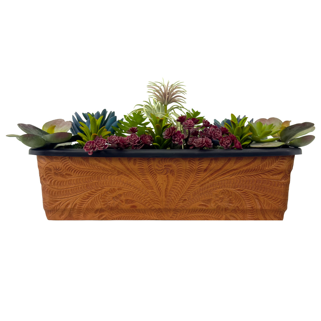 American West at Home eighteen inch rectangle planter in natural tan with hand tooled leather accents shown with flowers