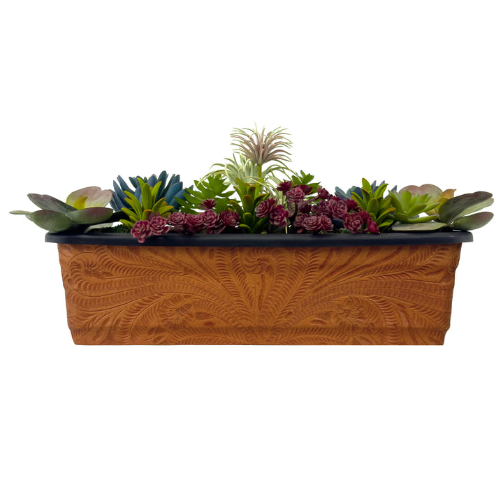 American West at Home eighteen inch rectangle planter in natural tan with hand tooled leather accents shown with flowers