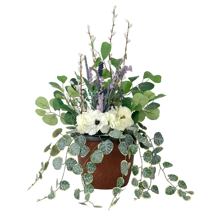 American West at Home ten inch round planter in medium brown with hand tooled leather accents shown with flowers