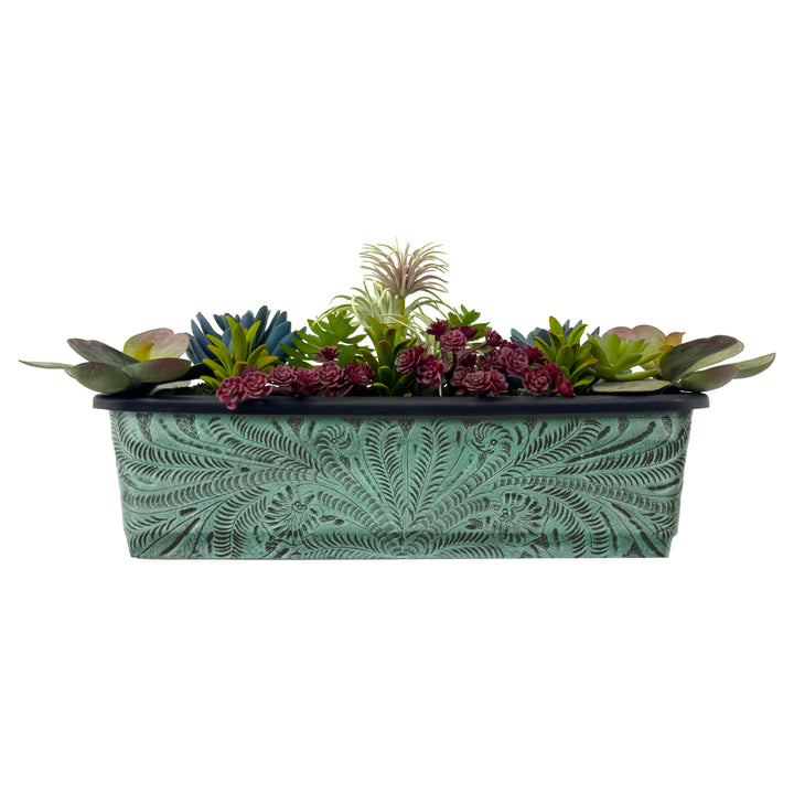 American West at Home fourteen inch rectangle planter in light turquoise with hand tooled leather accents shown with flowers