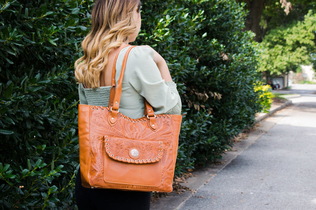 Lifestyle with model of Harvest Moon conceal carry tote in natural tan with hand tooled leather accents