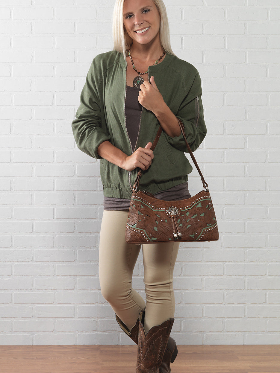 Lifestyle with model of Lady Lace shoulder bag in medium brown with hand tooled leather and cut out accents