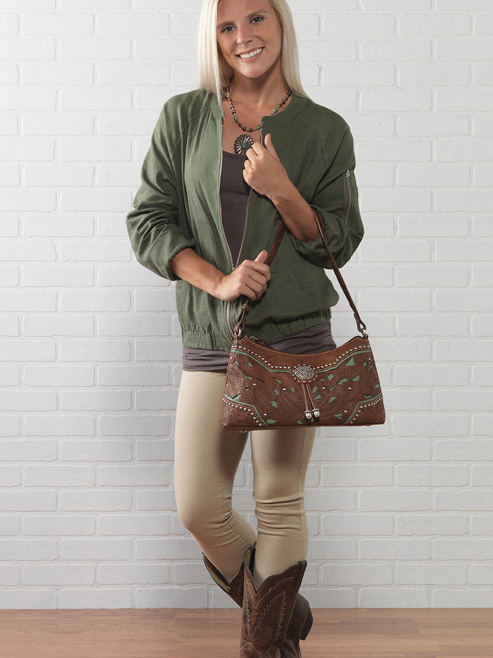 Lifestyle with model of Lady Lace shoulder bag in medium brown with hand tooled leather and cut out accents