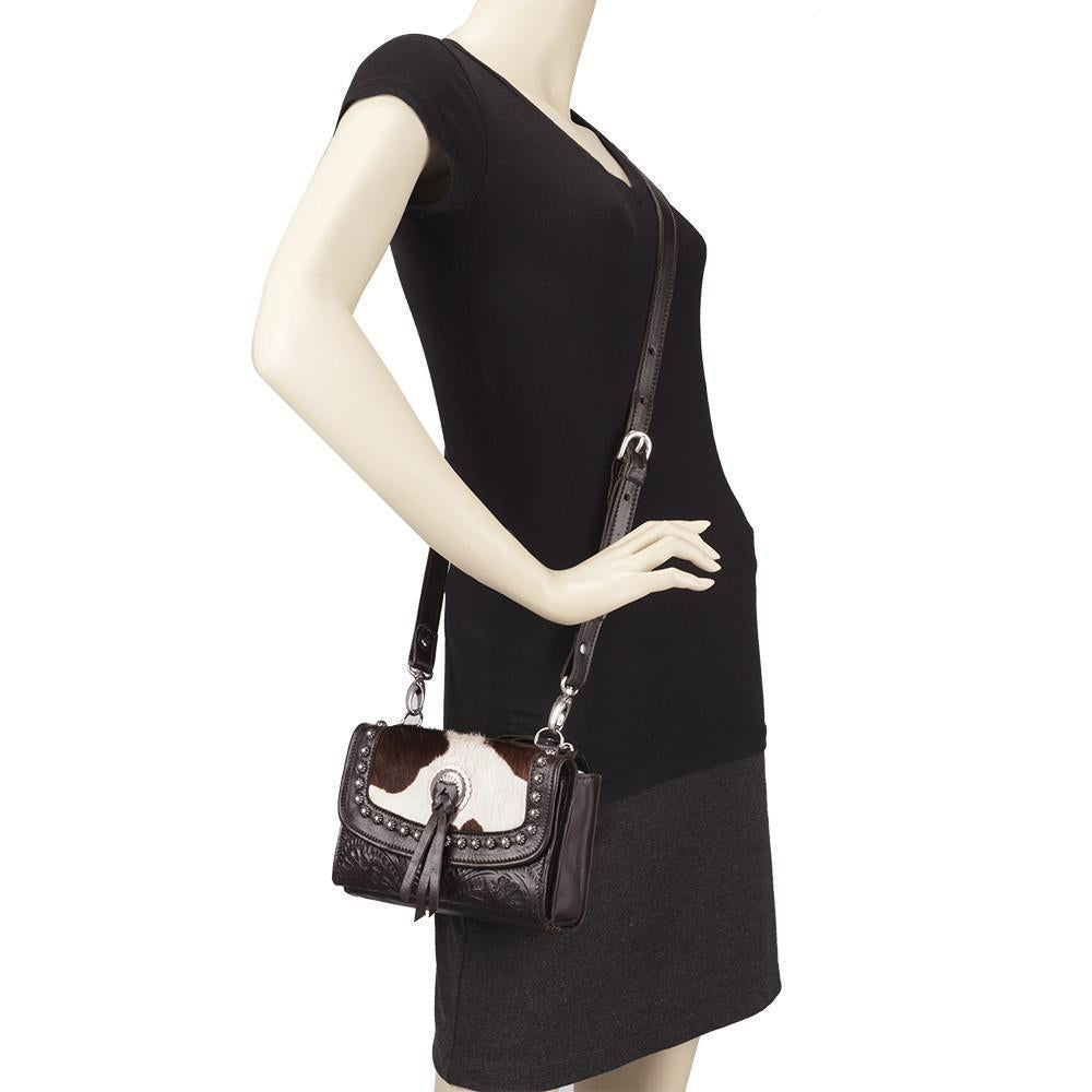 Cow Town crossbody bag in pony with hair-on hide leather accents on mannequin
