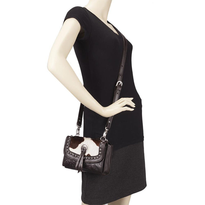 Cow Town crossbody bag in pony with hair-on hide leather accents on mannequin