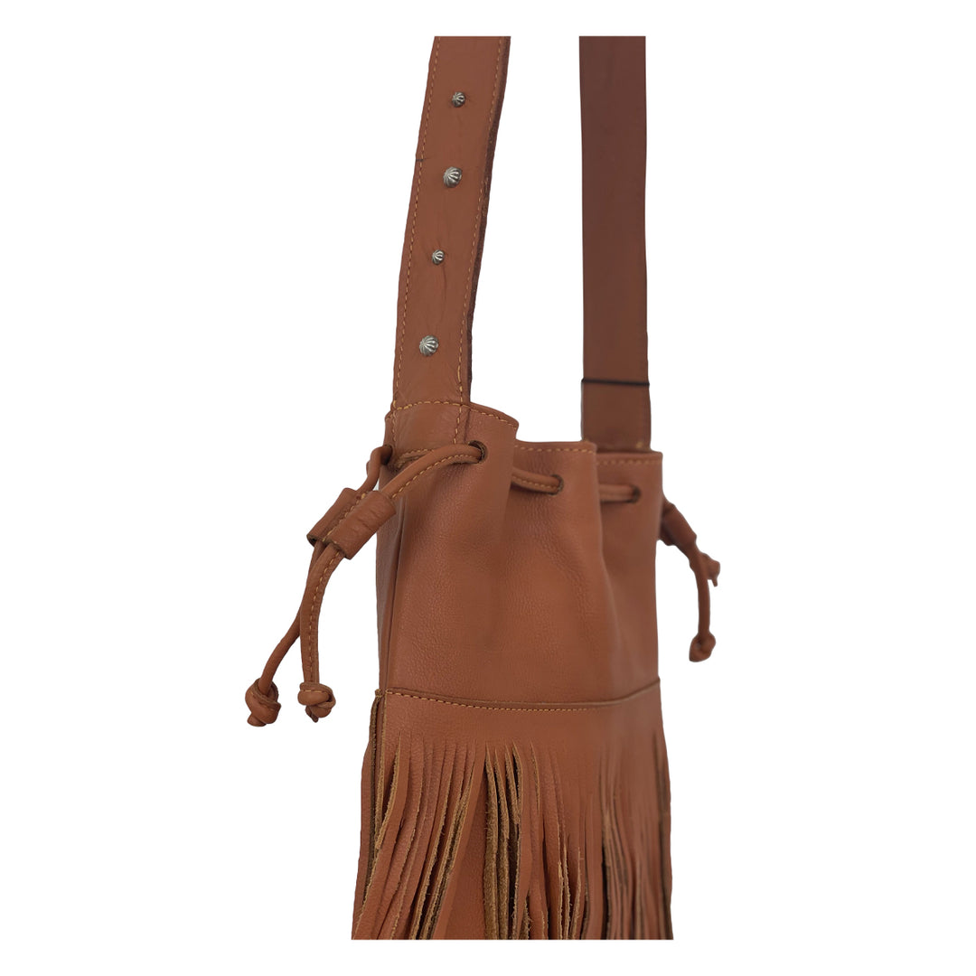 Close up  view of Fringed Cowgirl crossbody bag with fringe in natural tan drawstring closure