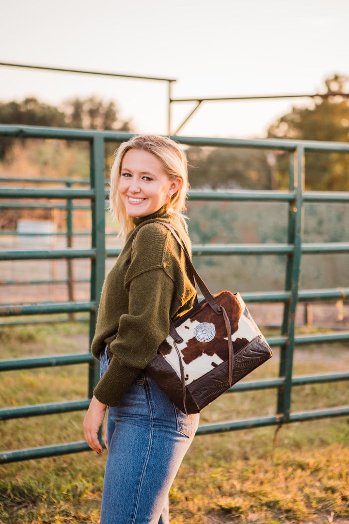 Lifestyle with model of Cow Town conceal carry tote in pony with hair-on hide leather accents