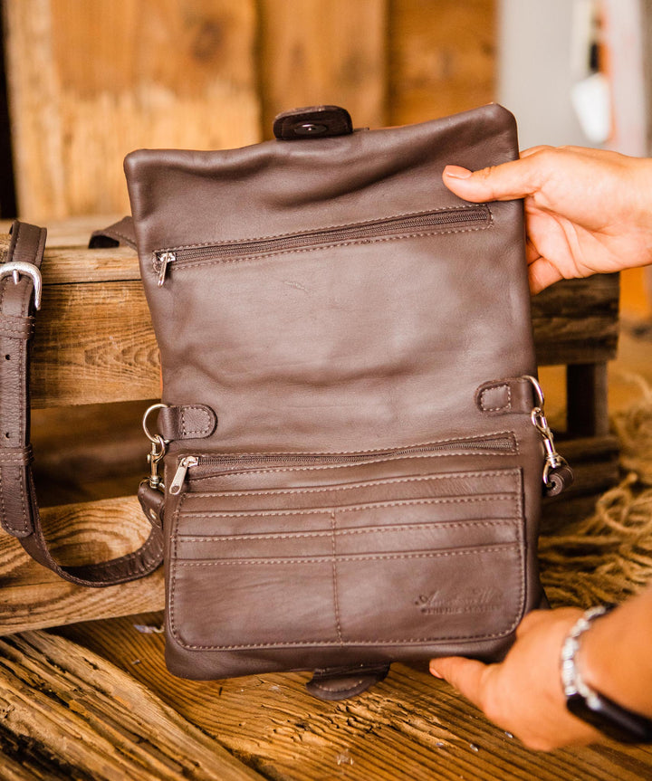 Inside view of Grab and Go crossbody bag foldover wallet/crossbody bag held open by model