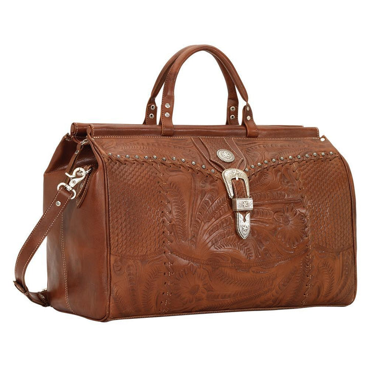 Side view of Classic Travel duffel bag in medium brown with hand tooled leather and buckle set accents