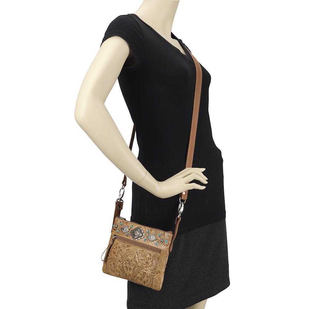 Turquoise Mesa crossbody/hip bag in light tan with hand tooled leather accents on mannequin