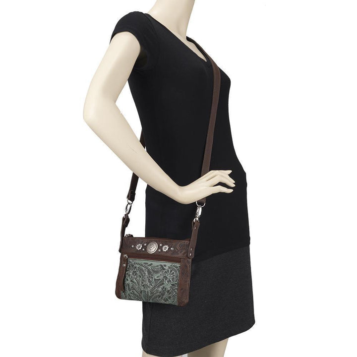 Canyon Bloom crossbody/hip bag in light turquoise with hand tooled leather accents on mannequin