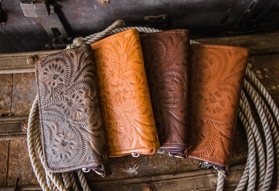 Assorted colors of Ladies zip-around wallet with hand tooled leather accents on chest with rope