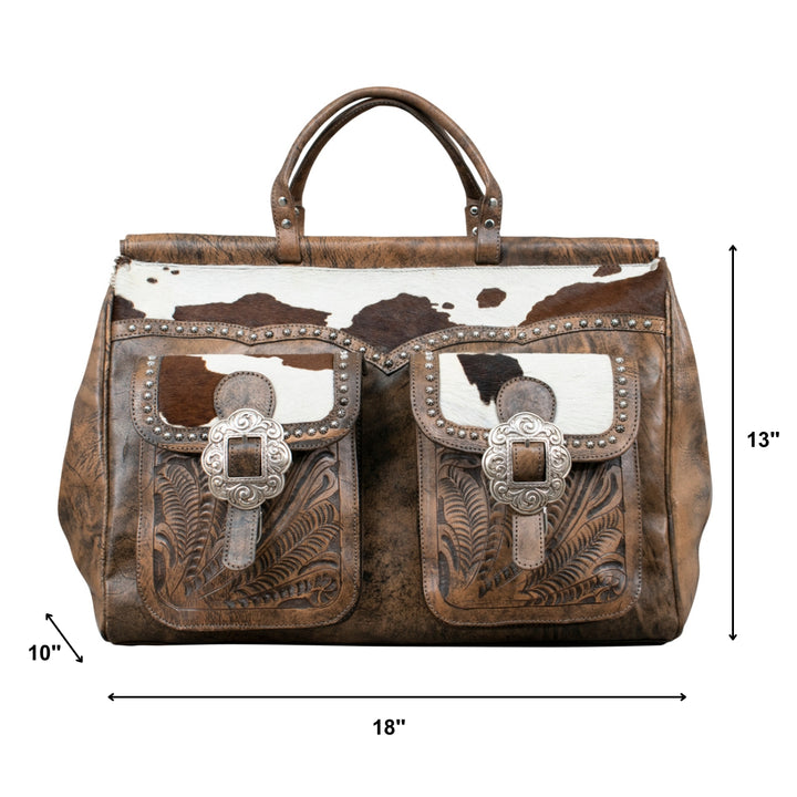 Cowtown duffel bag with front pockets in distressed charcoal brown with hand tooled leather and hair-on hide accents with dimensions