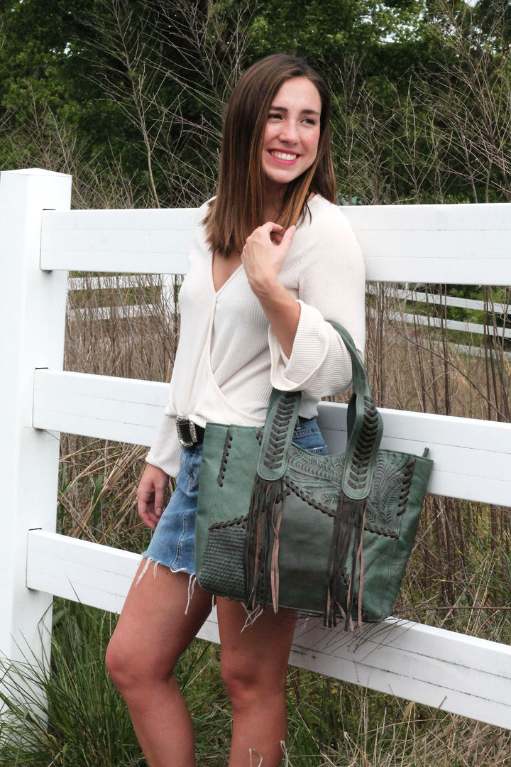 Lifestyle with model of Gypsy Patch tote in light turquoise with hand tooled leather accents