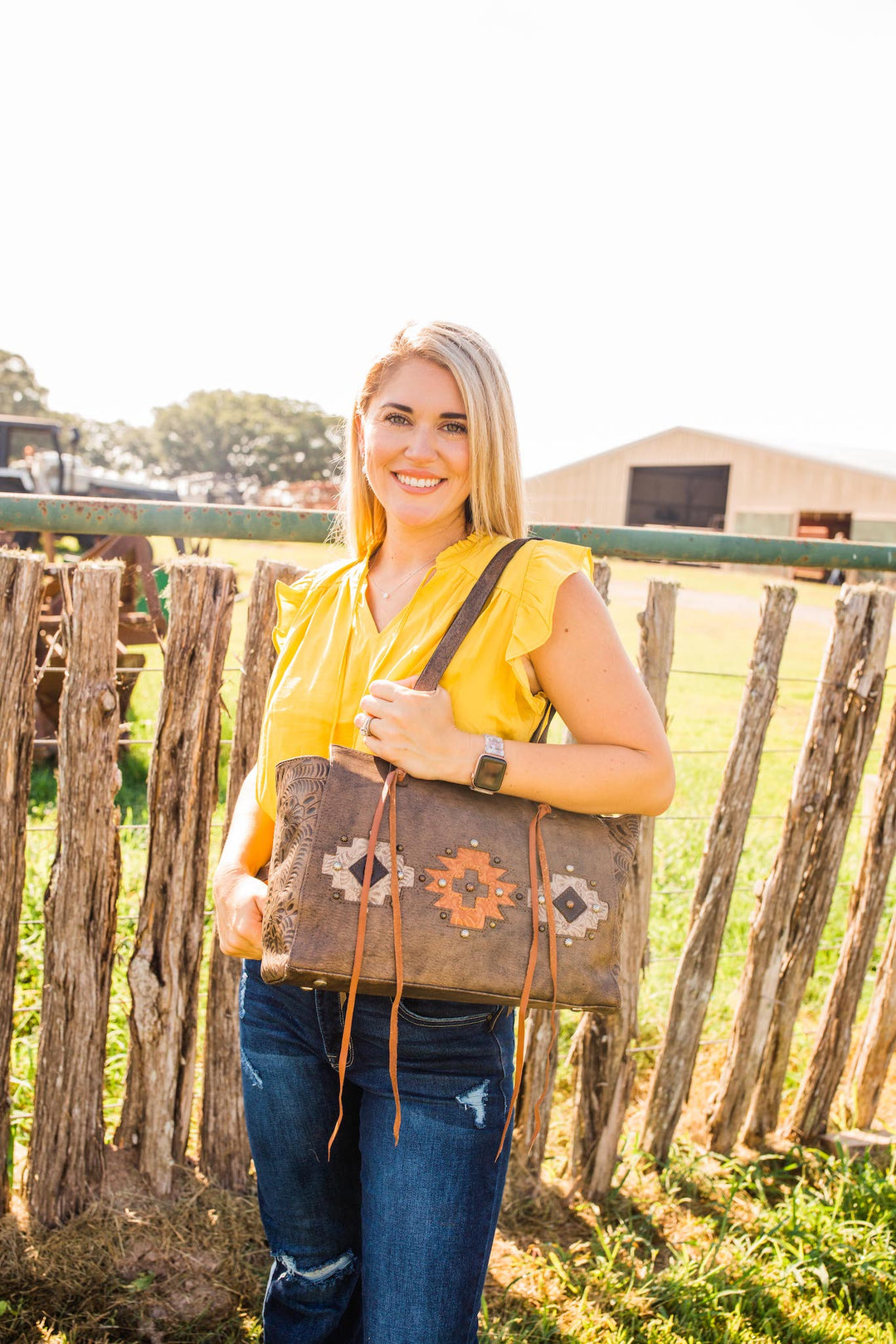 Lifestyle with model of Navajo Soul conceal carry tote in distressed charcoal brown with hand tooled leather accents