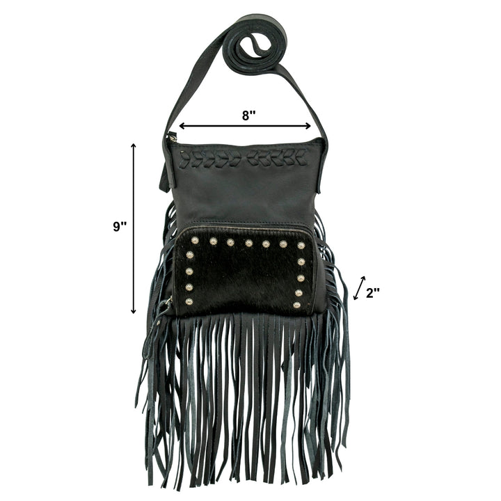 Lifestyle with model of Fringed Cowgirl crossbody in black with hair-on hide leather and fringe accents